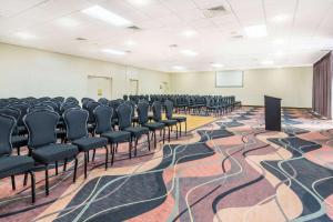 a conference room with chairs and a podium in it at Howard Johnson by Wyndham Lakeland in Lakeland