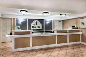 a hotel lobby with a counter with aulum sign at La Quinta Inn by Wyndham Albuquerque Northeast in Albuquerque +21 photos