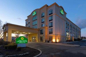 a hotel with a sign in front of a building at La Quinta by Wyndham Garden City in Garden City