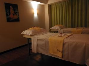 PACI Hotel&SPA客房内的一张或多张床位
