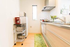 a kitchen with a sink and a refrigerator at KidsFreeUnder12yrs! 3LDK 6minShinjuku 3minJR 貸切一軒家 小学生以下無料 3LDK 新宿直通6分 JR高円寺駅徒歩3分 in Tokyo