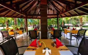 a restaurant with tables and chairs with red napkins at Greenwood Kemer Resort in Kemer