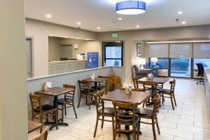 a restaurant with tables and chairs and a counter at Quality Inn Michigan City South in Michigan City