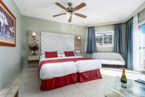 a bedroom with a large bed and a ceiling fan at Los Arcos in Nerja