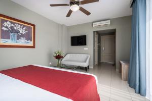 a bedroom with a bed and a ceiling fan at Los Arcos in Nerja