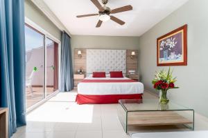 a bedroom with a bed and a glass table at Los Arcos in Nerja