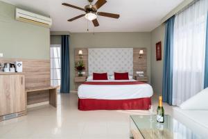 a bedroom with a large bed with red pillows at Los Arcos in Nerja