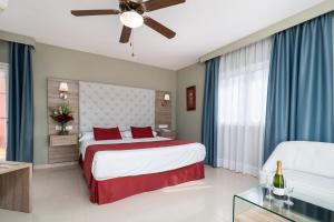 a hotel room with a bed and a couch at Los Arcos in Nerja