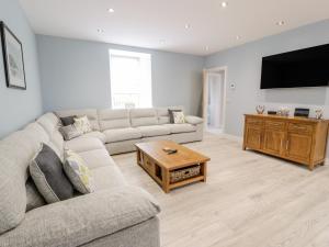 a living room with a couch and a coffee table at Meadowbank in Girvan