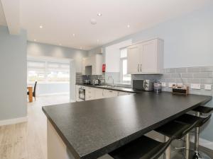 a kitchen with a black counter top in a room at Meadowbank in Girvan