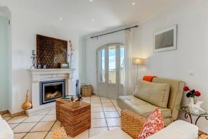a living room with a couch and a fireplace at Casa D'Luz in Carvoeiro