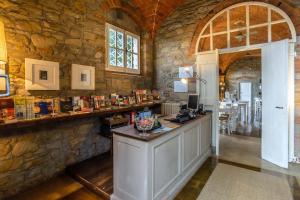 a room with a counter in a stone wall at Villa Cassia di Baccano in San Giustino Valdarno