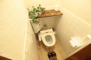 a small bathroom with a toilet in a stall at Gunjonoma Yadokari in Okayama
