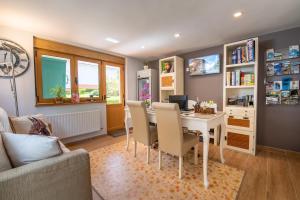 a home office with a desk and a table and chairs at Hotel el Pinar in Villapedre