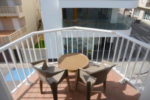 a balcony with a table and chairs on a porch at Rallye Hotel in L'Escala
