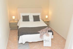 a bedroom with a large bed with two night stands at Rallye Hotel in L'Escala