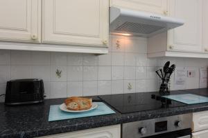 a kitchen with a plate of food on a counter at Riverside 6 in Dartmouth