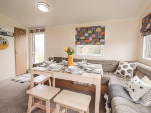 a living room with a table and a couch at Moonstone Lodge in Dover