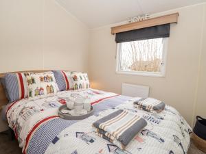 a bedroom with a bed with a tray with towels on it at Moonstone Lodge in Dover