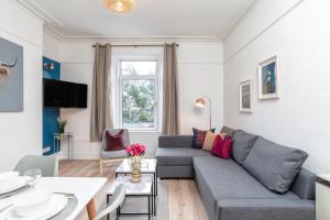 a living room with a couch and a table at West Mount Apartments in Aberdeen