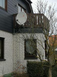 a satellite dish on the side of a house at FEWO Tietz in Wolmirstedt