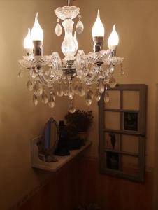a chandelier hanging in a room with a mirror at Casa Segota in Veli Iž