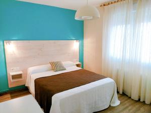 Posteľ alebo postele v izbe v ubytovaní Apartamentos Rodeiramar 2A