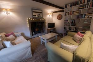 a living room with two couches and a fireplace at Swanfold in Hebden Bridge