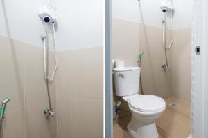 a bathroom with a toilet and a shower at OYO 561 Abn Hostel in Bacolod