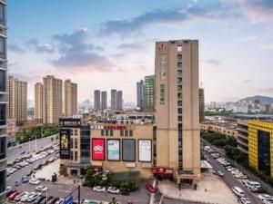 a view of a city with cars and buildings at Jinjiang Inn Select Hangzhou Binjiang University Town Puyan Metro Station in Hangzhou