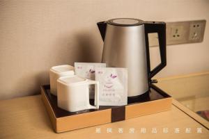a coffeemaker sitting on top of a table at Lavande Hotel Guiyang Huaguoyuan Shopping Mall in Guiyang