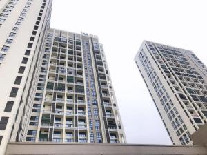 two tall buildings in a city at IU Hotel Guiyang Olympic Sports Center China Resources Vientiane in Guiyang