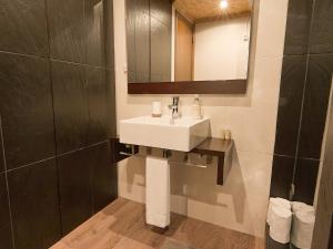 a bathroom with a sink and a mirror at Chalé | Penhas da Saúde - Serra da Estrela in Penhas da Saúde