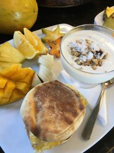a plate of food with a pancake and a bowl of fruit at Vista Villas in Ojochal