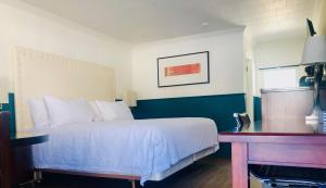 a hotel room with a bed and a desk at The Voy in Schreiber