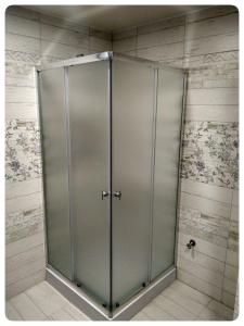 a large glass shower door in a room at 2х кімнатна квартира на вулиці Лесі Українки in Uzyn
