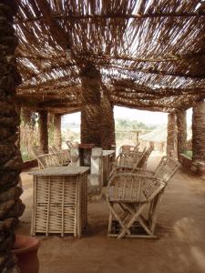 a group of chairs and a table in a pavilion at Badry Sahara Camp in Bawati