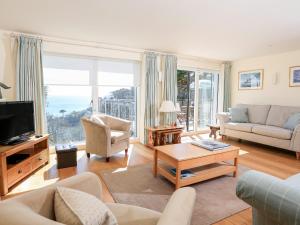 a living room with a view of the ocean at Courtenay Villa in Salcombe