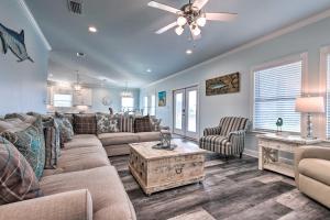 a living room with a couch and a table at Luxe Spacious Stilted Home with Kayaks Walk to Beach in Dauphin Island