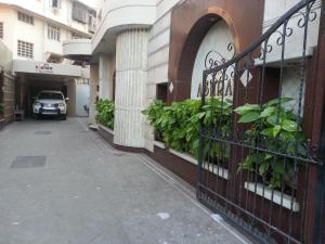 a car parked on a street next to a building at Hotel Ashray International, Sion in Mumbai