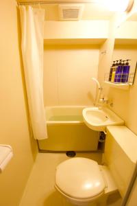 a small bathroom with a toilet and a sink at Akasaka Koyu Building 801 in Tokyo