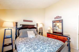 a bedroom with a bed and a dresser and a mirror at Pines 4048 in Pagosa Springs