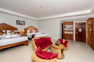 Ein Bett oder Betten in einem Zimmer der Unterkunft Aristocrat Residence & Hotel