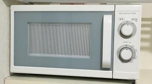 a microwave oven sitting on top of a shelf at Coco Fukuoka Chiyo in Fukuoka
