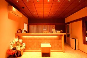 a kitchen with a counter and a table with flowers at 高野山 宿坊 不動院 -Koyasan Shukubo Fudoin- in Koyasan