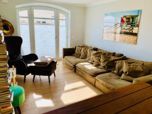 a living room with a couch and a chair at Meer-Lust-Sylt Haus Mateika in Westerland