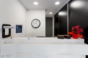 a office with a clock on the wall and a desk at Supreme Luxury Suites by Athens Stay in Athens