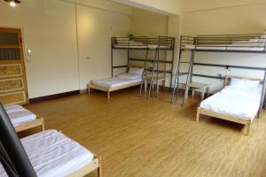 Voodi või voodid majutusasutuse Chiayi Petite Hostel toas