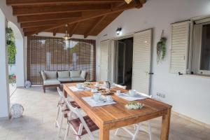 a wooden table and chairs on a patio at La Casa dell Olivo in Castiadas