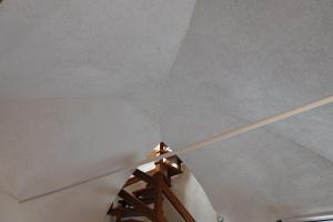 a staircase with a white ceiling and a wooden rail at Agriturismo del Pigato - Bio Vio in Albenga